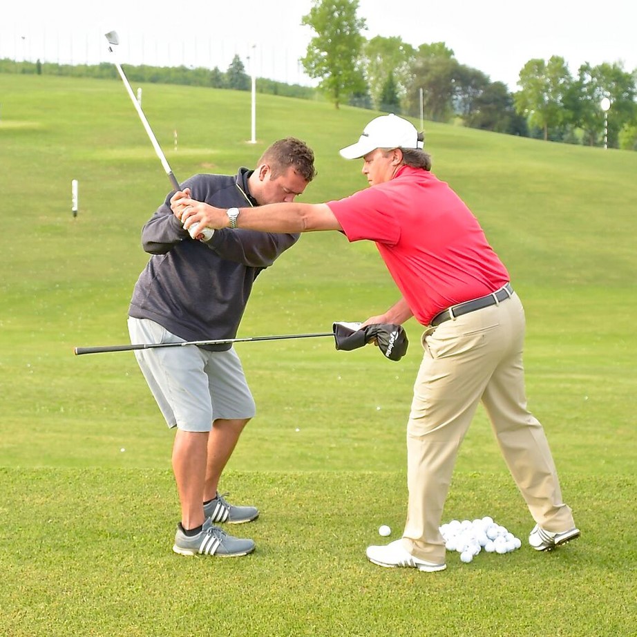 Instructor giving tips on golf course
